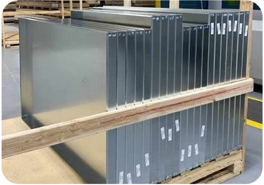 Finished galvanized ProSteel curtain wall backpans secured on pallets