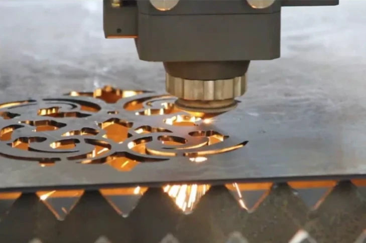 Laser cutting an intricate pattern into a sheet of steel
